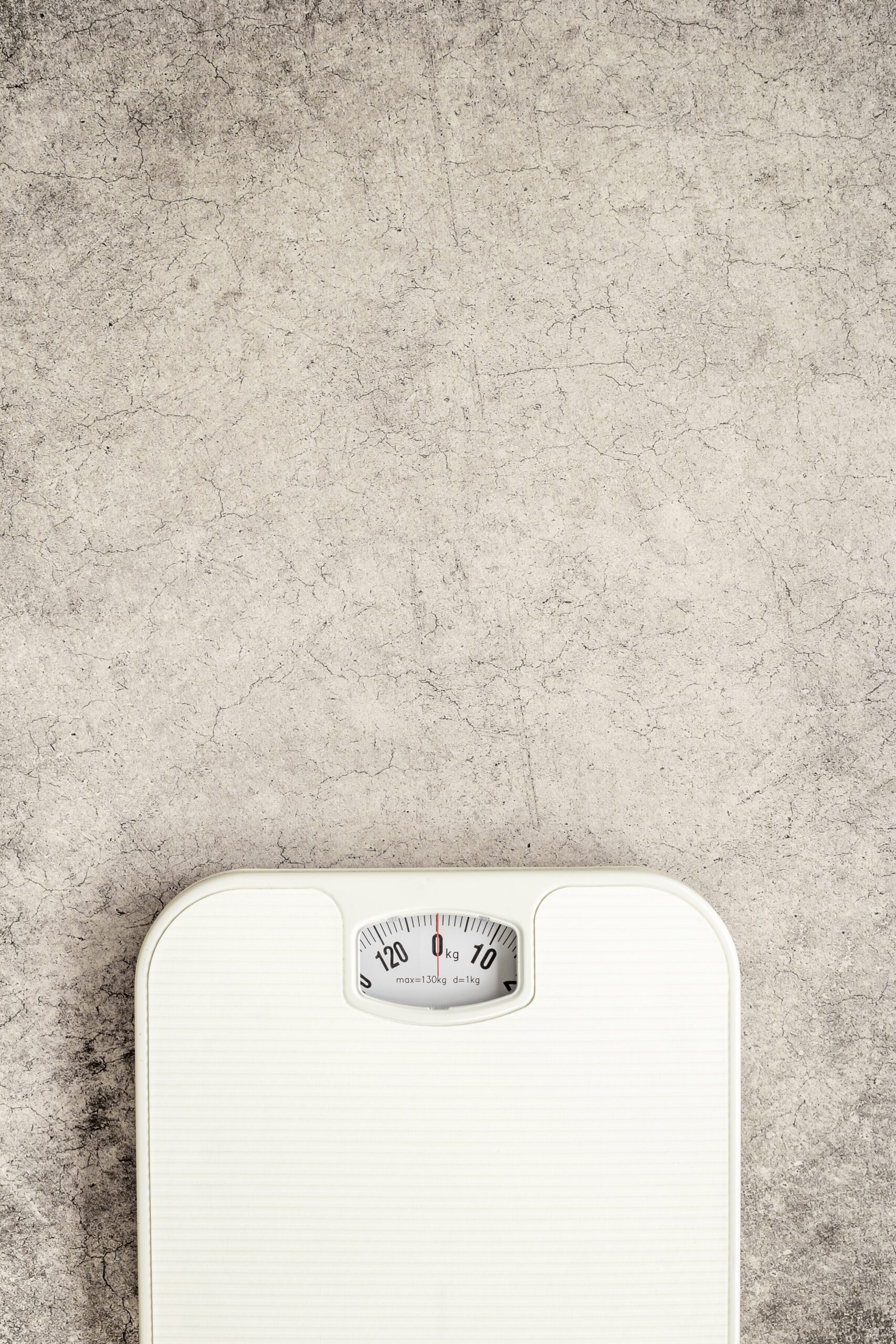 White weight scales on the floor. Weight measurement and loss concept.