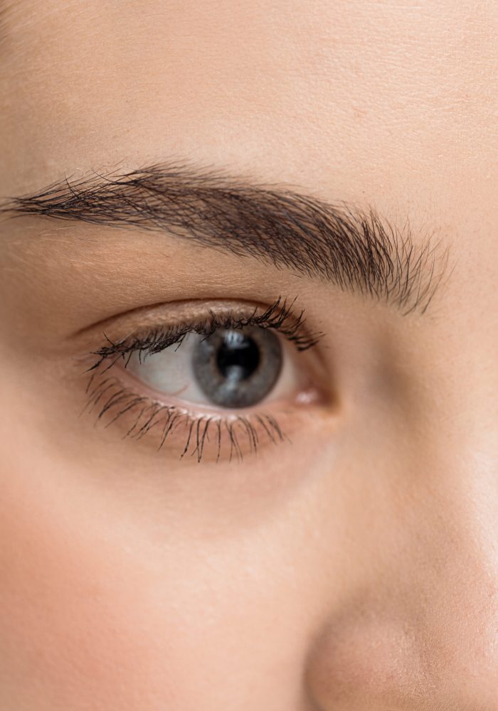 close up of attractive young woman with blue eye looking away