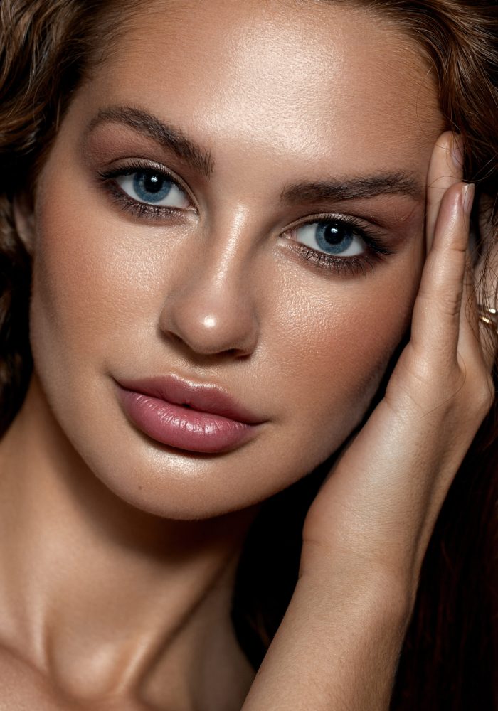 Close-up portrait of a beautiful woman with blue eyes. Strong skin texture. Natural makeup, clean healthy skin.