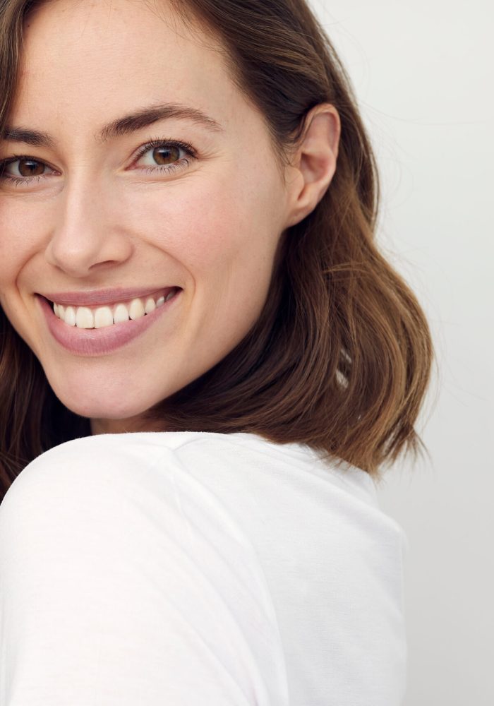 Portrait of beautiful naturally brunette woman, smiling and look