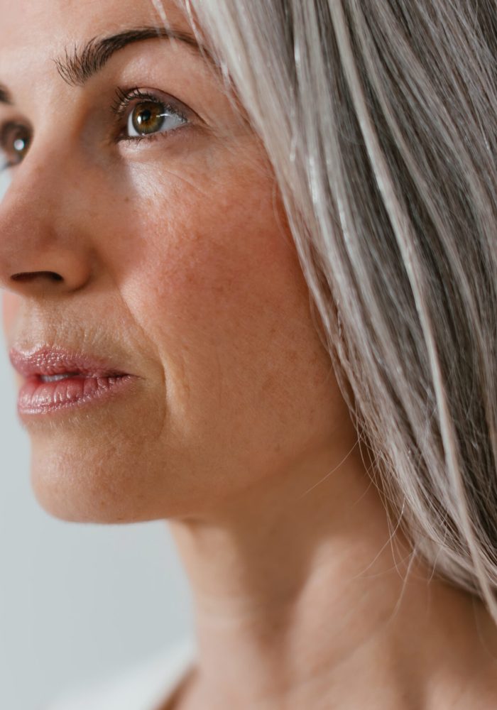 Mature woman with gray hair looking away