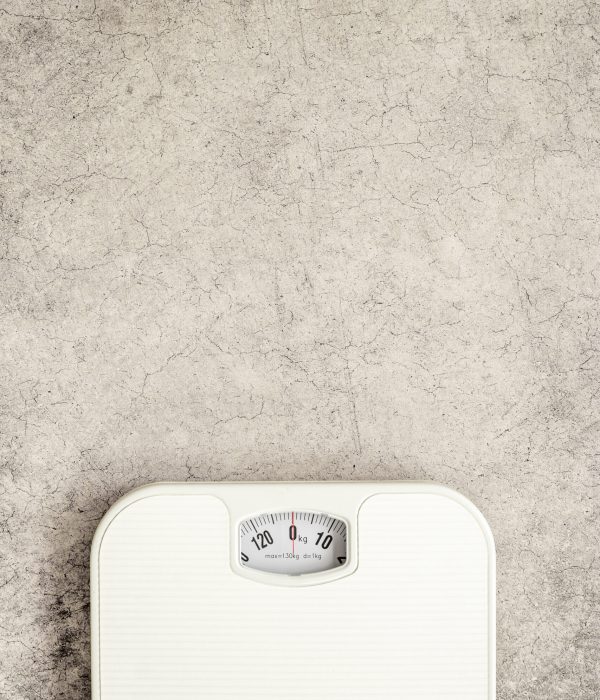 White weight scales on the floor. Weight measurement and loss concept.