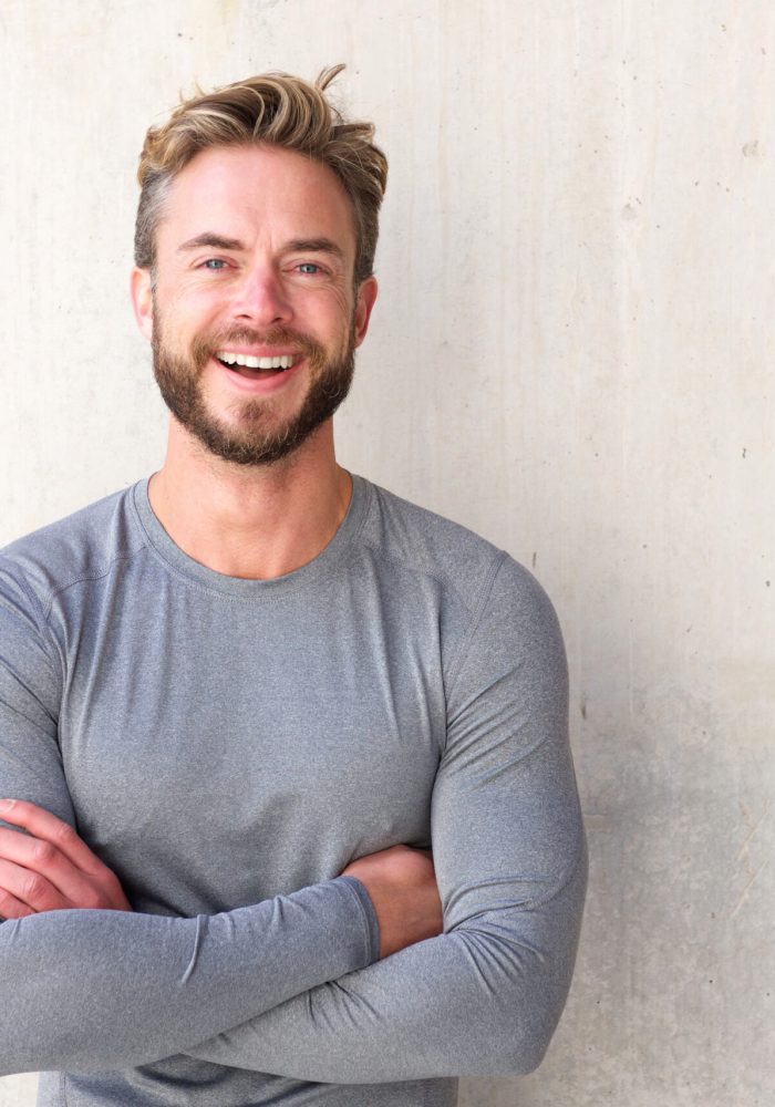 Portrait of a smiling cool guy with arms crossed